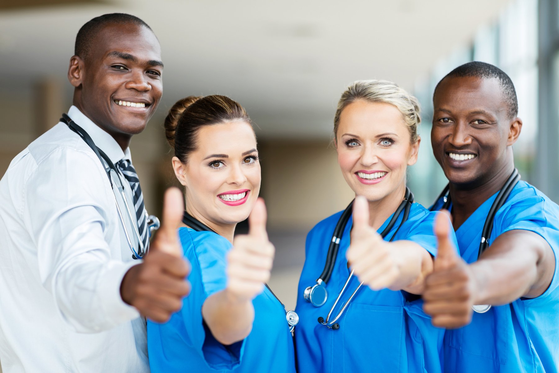 group of healthcare workers thumbs up